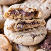 stack of peanut butter cookies with cut in half cookies on top stack with Nutella inside