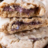 stack of peanut butter cookies with cut in half cookies on top stack with Nutella inside