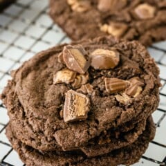 Overhead shot of soft chocolate peanut butter cup cookies on a metal cooling rack