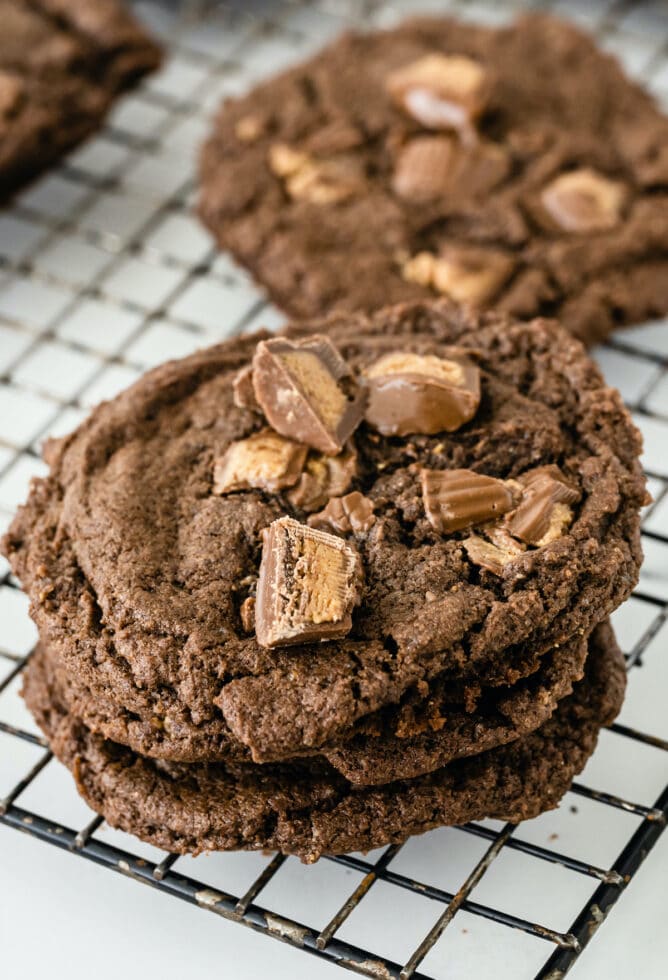 Overhead shot of soft chocolate peanut butter cup cookies on a metal cooling rack