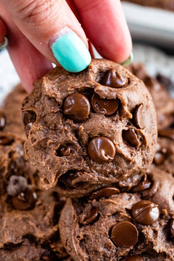 Hand holding up one chocolate cake mix cookie
