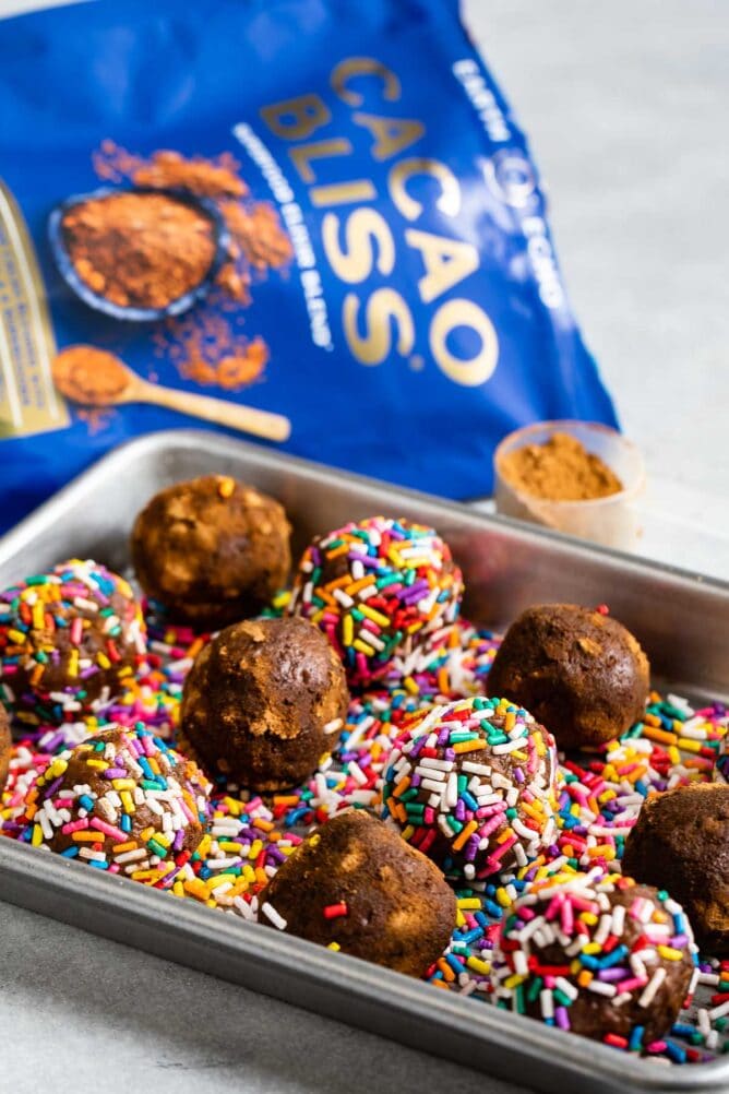Tray full of double chocolate chip edible cookie dough balls rolled in rainbow sprinkles