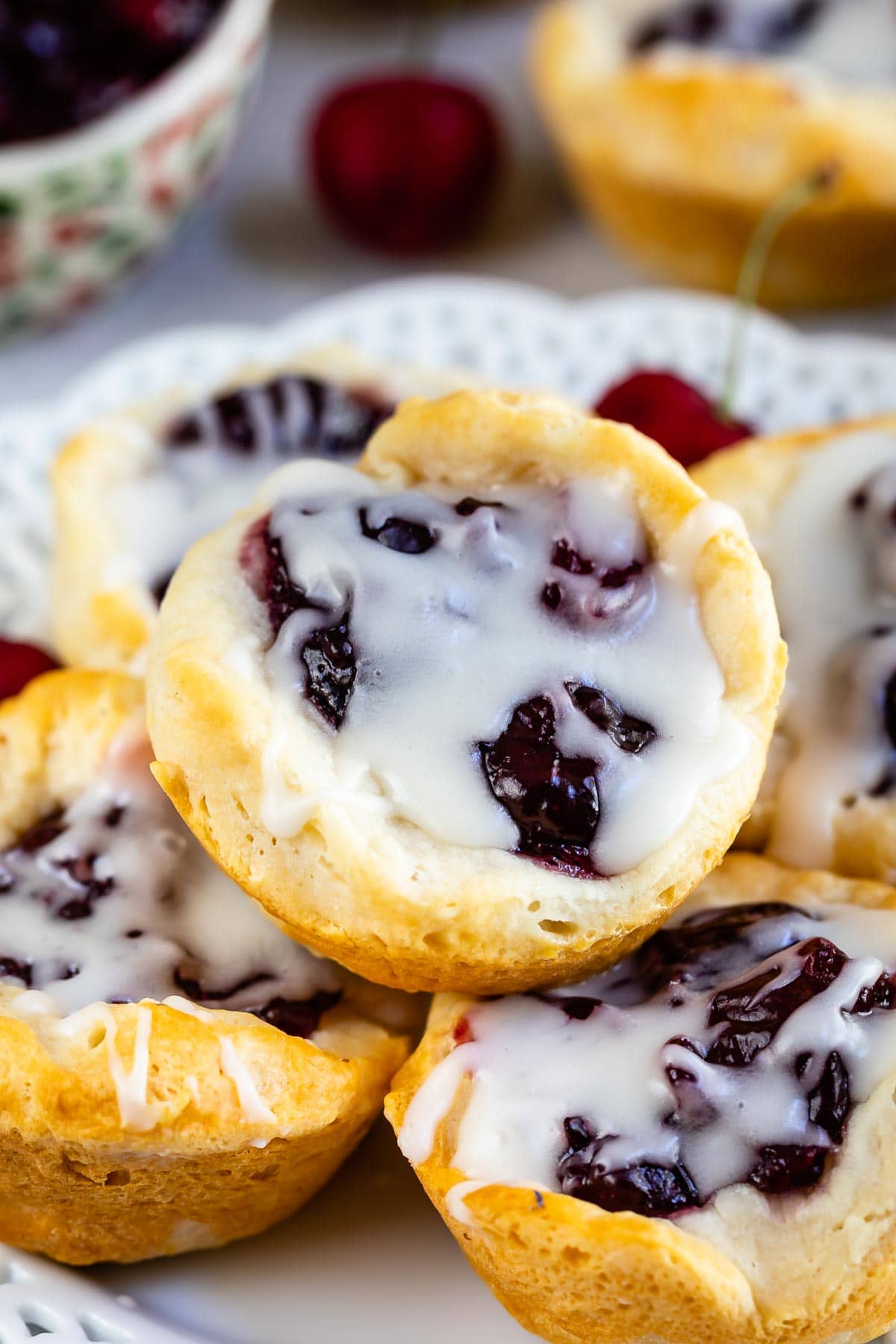 cherry pie danish with drizzle on a stack of bites