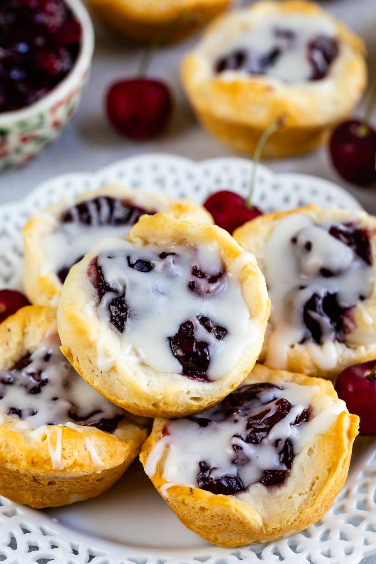 cherry pie danish with drizzle on a stack of bites