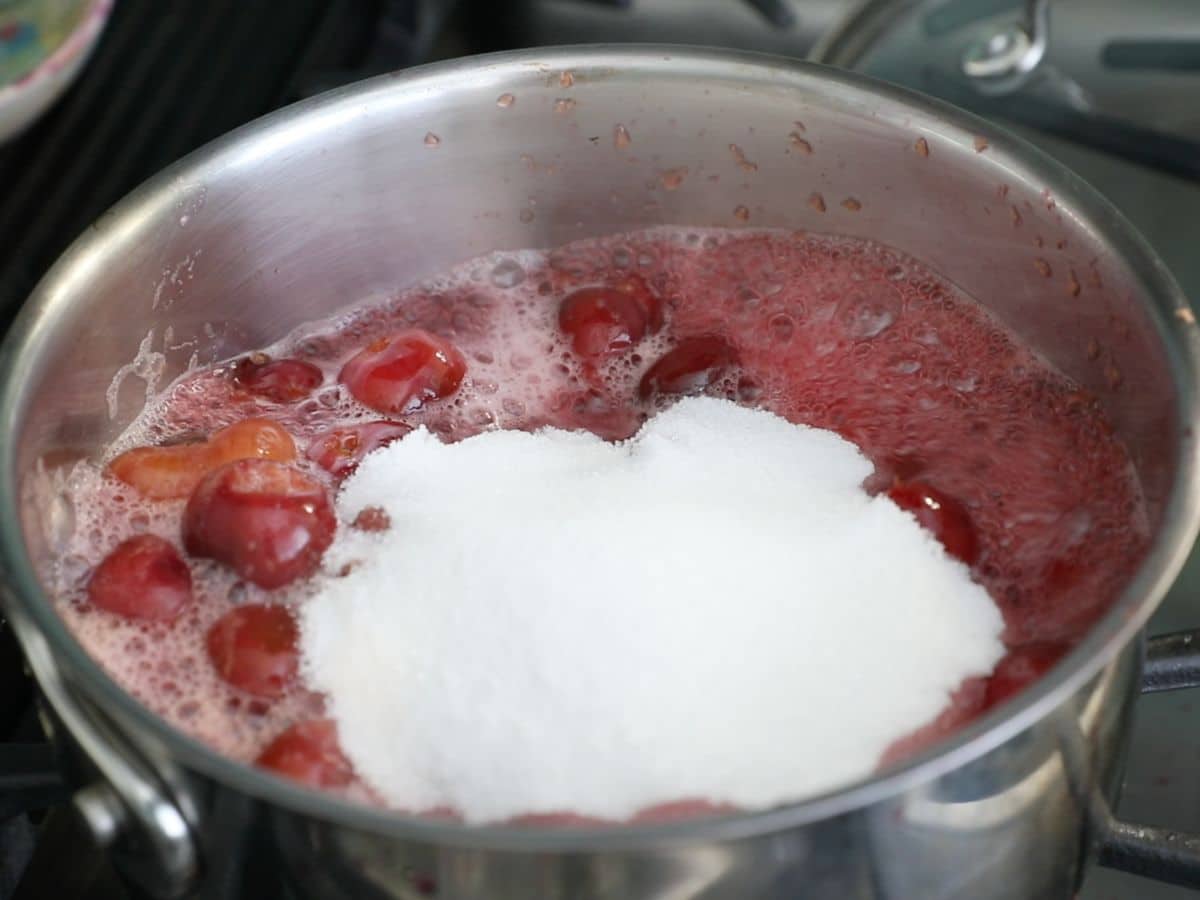 boiled cherries in saucepan with sugar