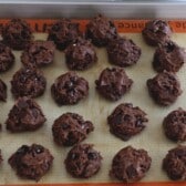 cookie dough balls on silpat lined cookie sheet.