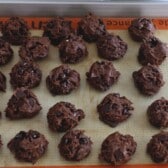 cookie dough balls on silpat lined cookie sheet.