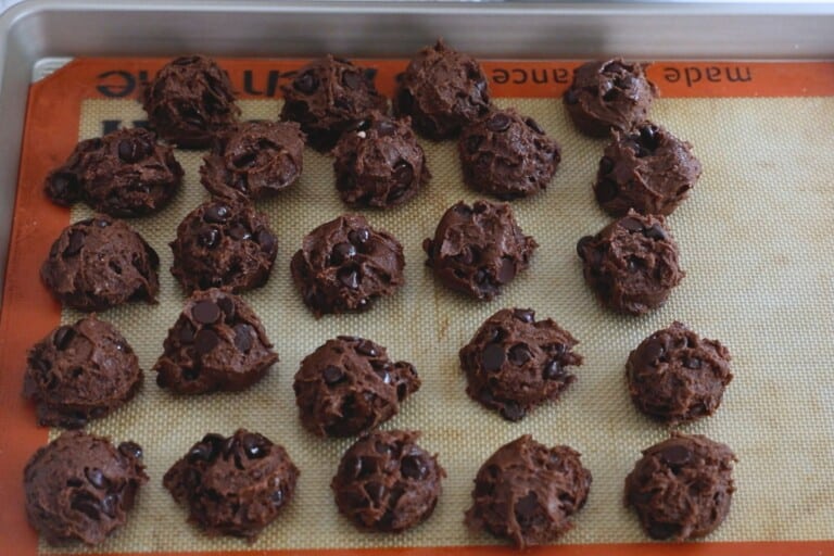 cookie dough balls on silpat lined cookie sheet.