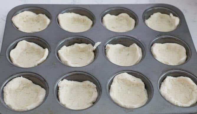 muffin pan with biscuit dough
