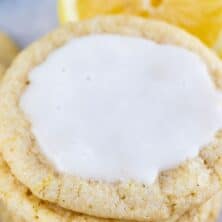 Stack of lemon cookies with icing on the top cookie and recipe title on bottom of image