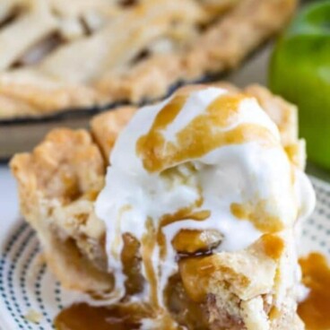 One slice of salted caramel apple pie with melting ice cream on top