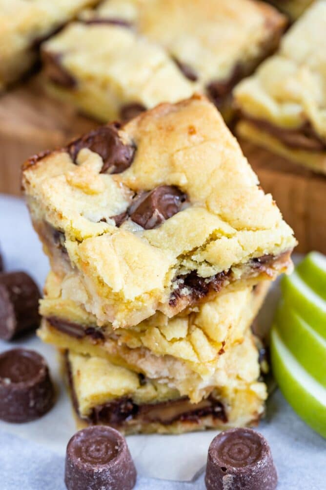 Stack of Caramel Apple Gooey Bars with rolo candies around them