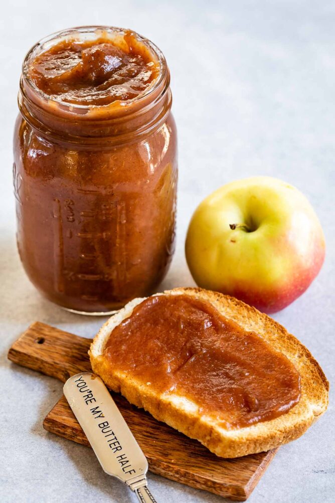Apple butter in a mason jar and spread on a piece of toast