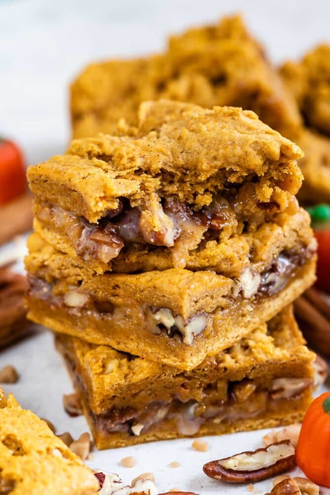 Three pumpkin gooey bars stacked on top of eachother with top bar missing a bite