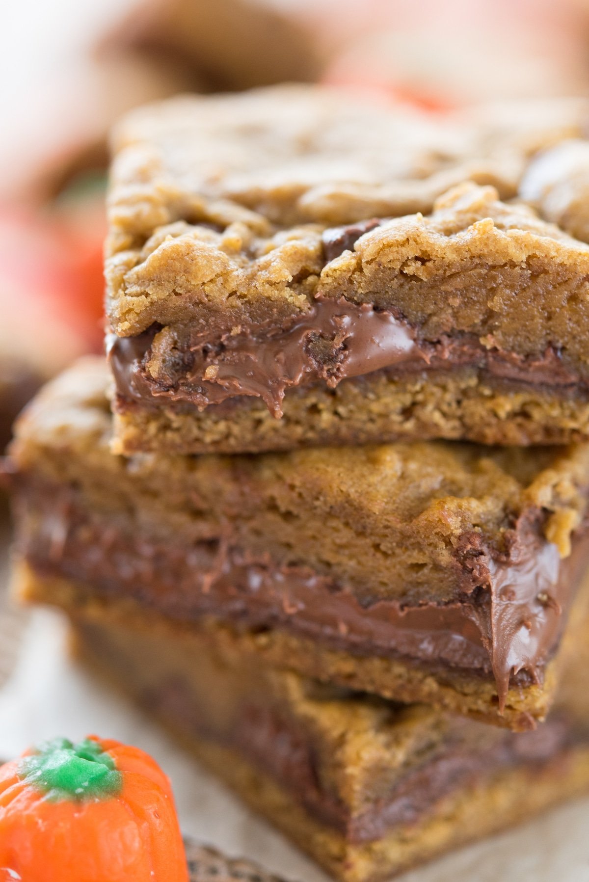 Close up shot of three pumpkin nutella cookie bars