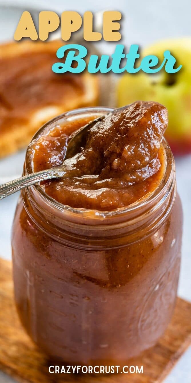Apple butter in a mason jar with a spoon coming out and recipe title on top of image