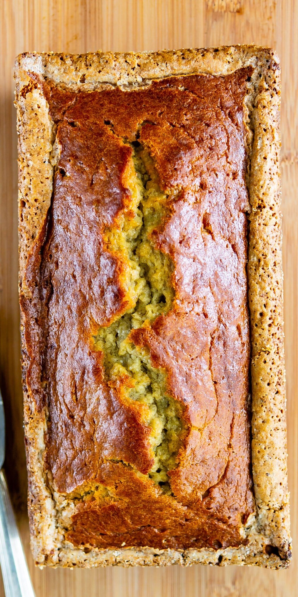 whole banana bread overhead photo with crack down the middle.