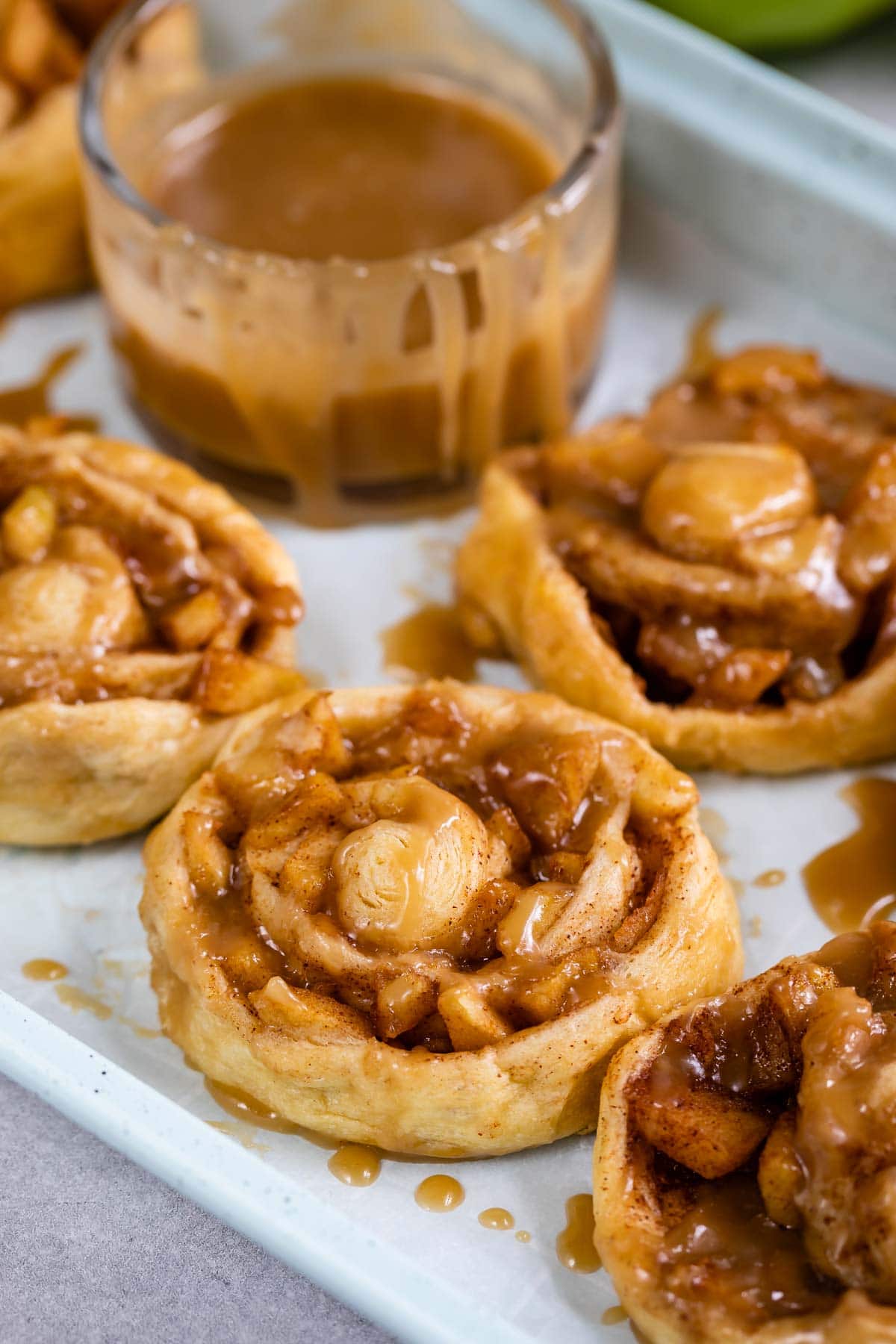 Close up shot of easy caramel apple cinnamon rolls with caramel topping
