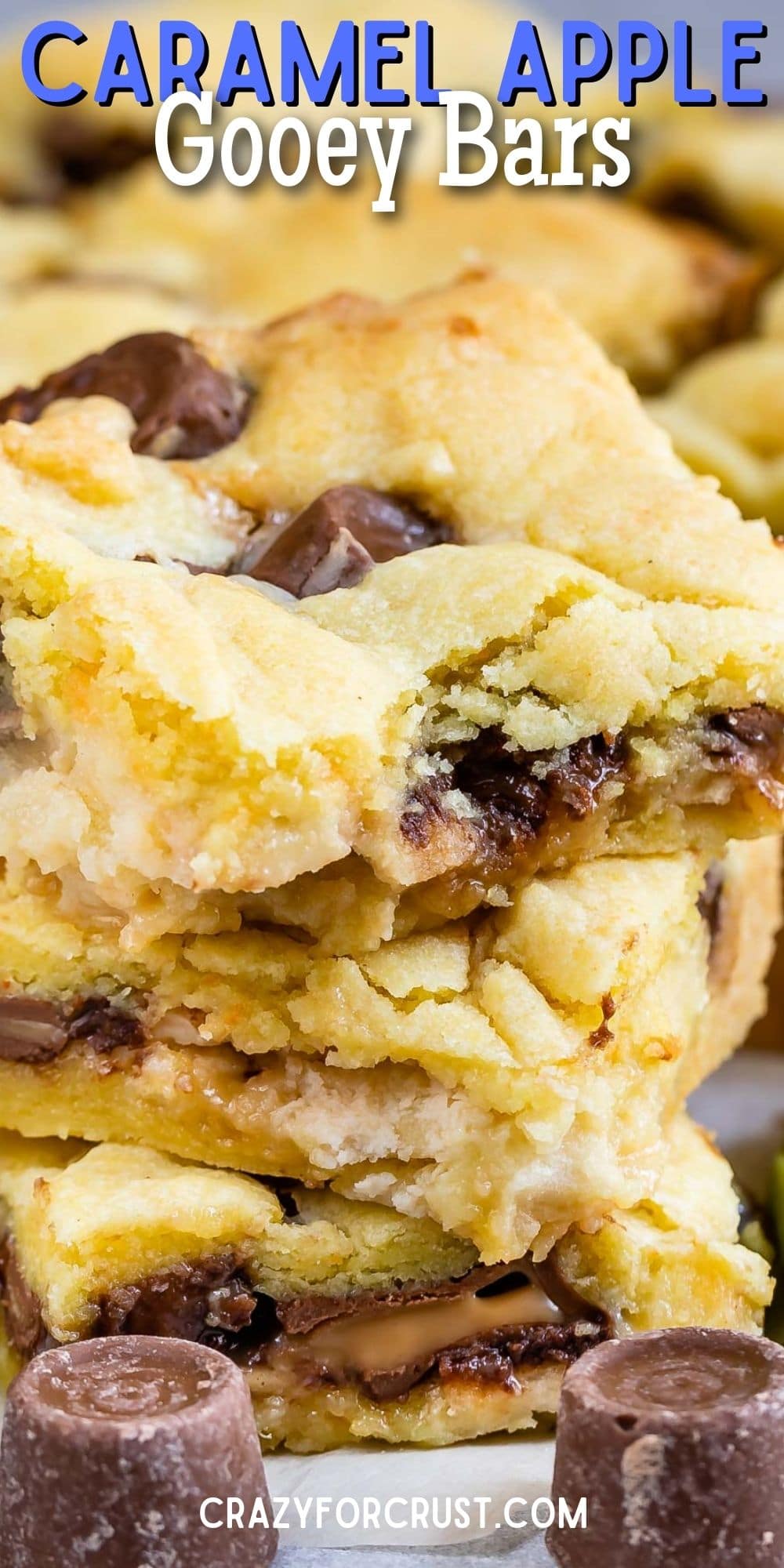 Stack of Caramel Apple Gooey Bars with rolo candies around them and recipe title on top of image