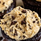 Chocolate cupcakes with cookie dough frosting and mini chocolate chips on top and recipe title on top of image