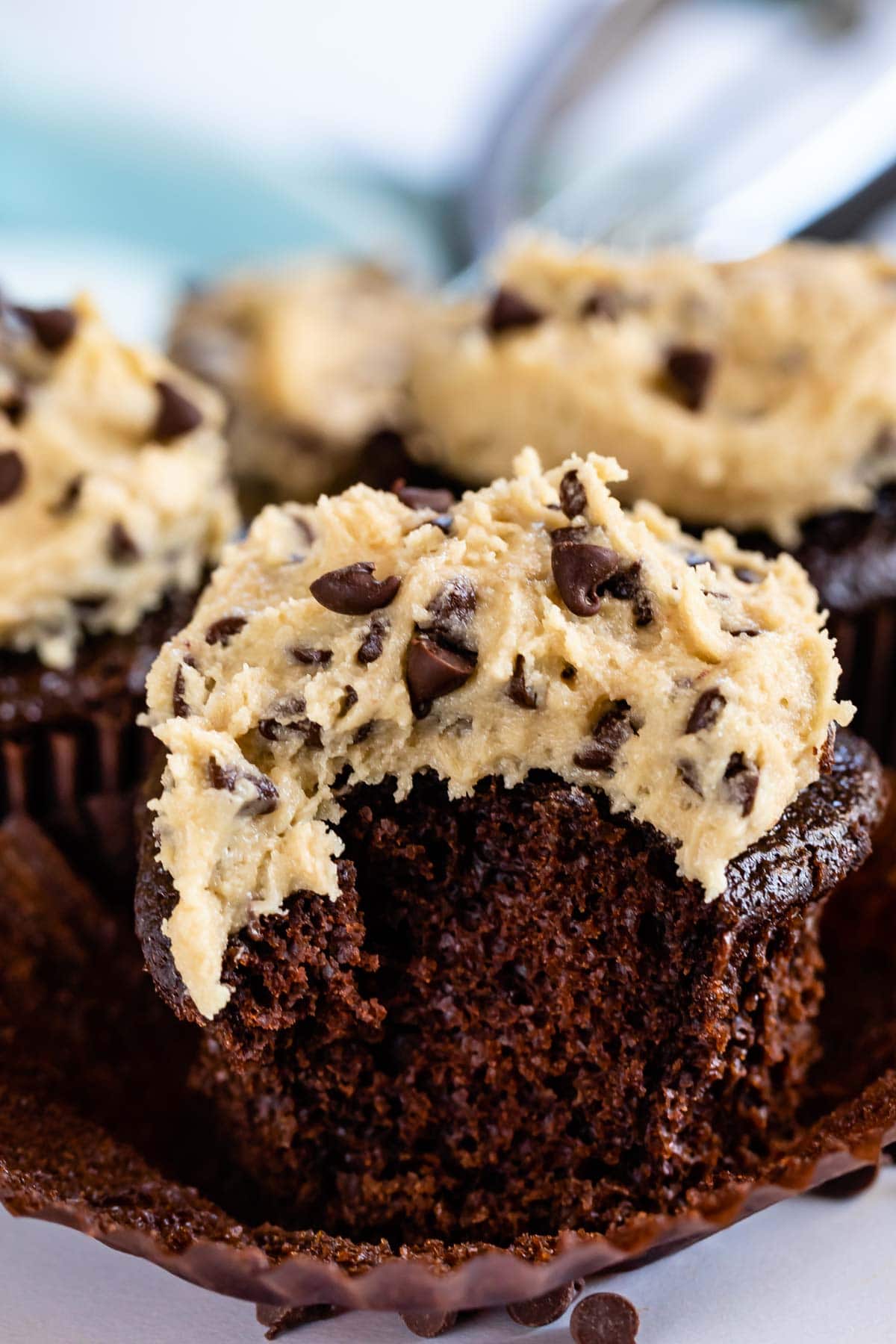 Unwrapped cookie dough cupcake with one bite missing