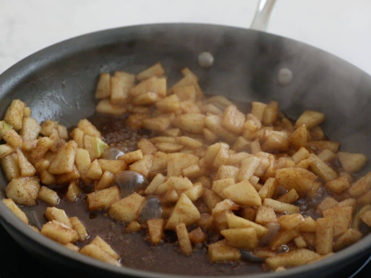 cooked apples in frying pan.