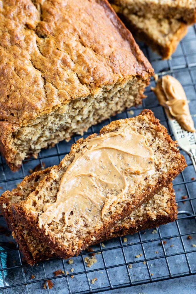 Overhead shot of peanut butter banana loaf and slices topped with a maple glaze