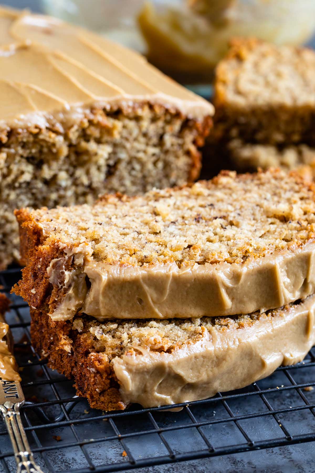 Two slices of peanut butter banana loaf bread topped with maple glaze