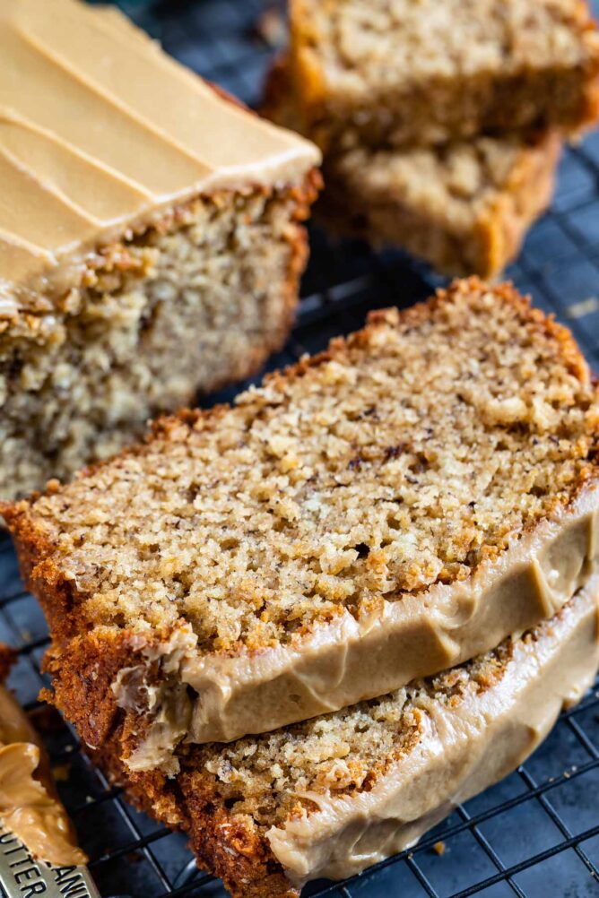 Two slices of peanut butter banana loaf bread topped with maple glaze