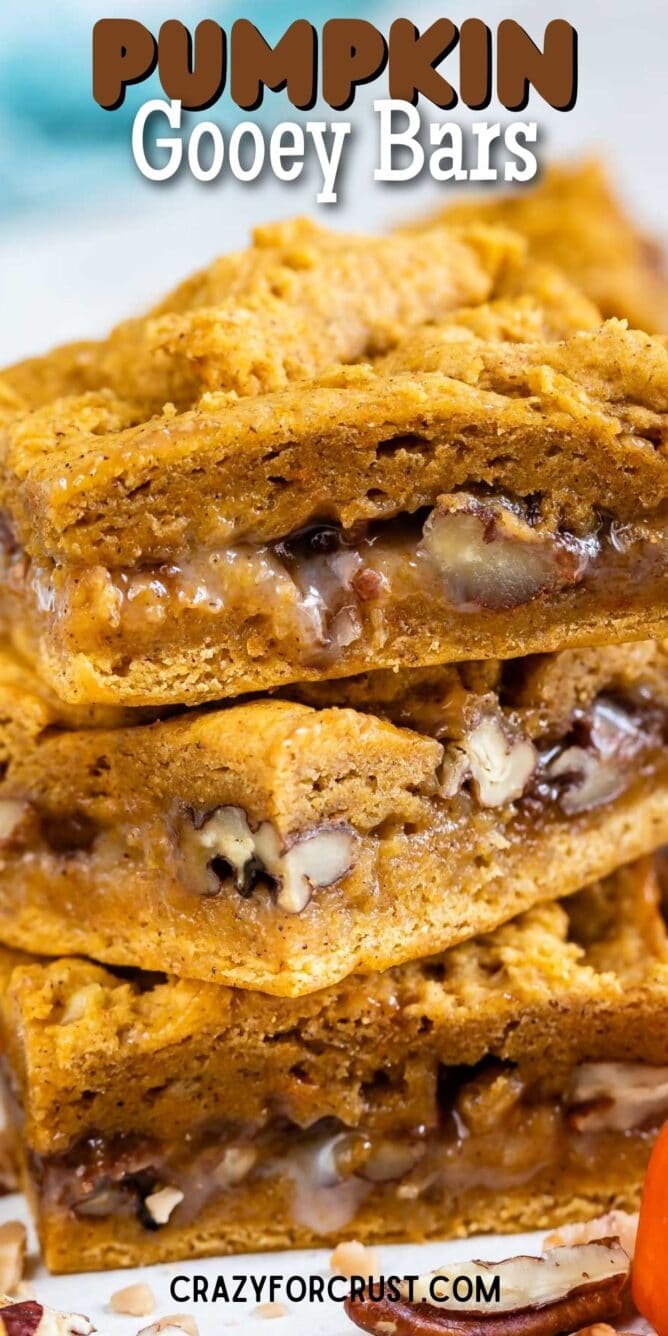 Close up shot of pumpkin gooey bars stacked on eachother with recipe title on top of image
