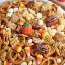 Large bowl of pumpkin spice chex mix with recipe title on top of image
