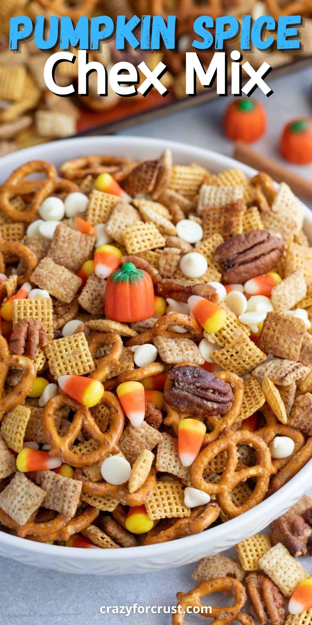 Large bowl of pumpkin spice chex mix with recipe title on top of image