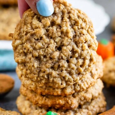 Hand holding pumpkin spice oatmeal cookie