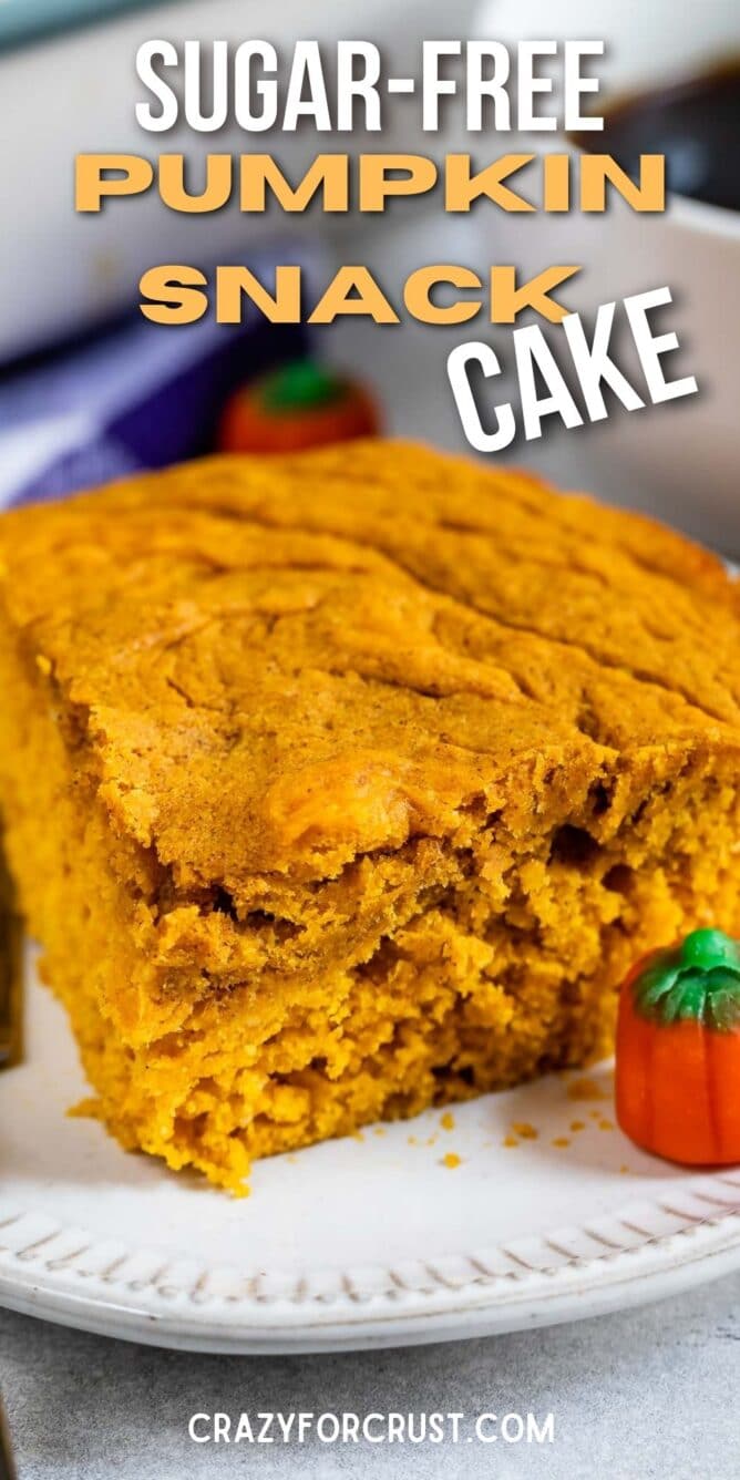 Slice of pumpkin snake cake on a plate next to pumpkin candies and recipe title on top of image