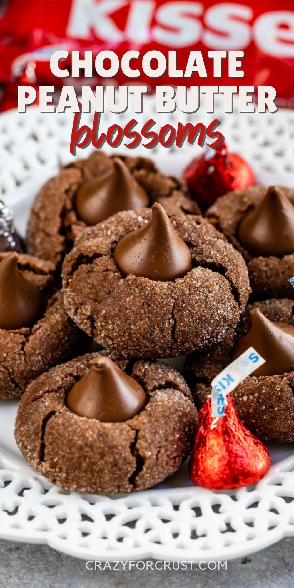 Plate full of chocolate peanut butter blossoms with Hershey kisses sprinkled on plate with recipe title on top of image