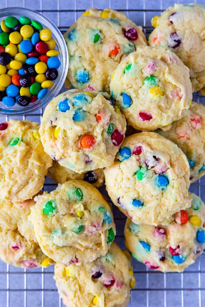 Overhead shot of M&M Cake Mix Cookies next to a bowl of M&Ms