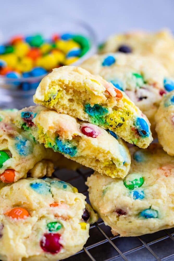 Close up shot of one M&M cake mix cookie split in half to show insides of cookie