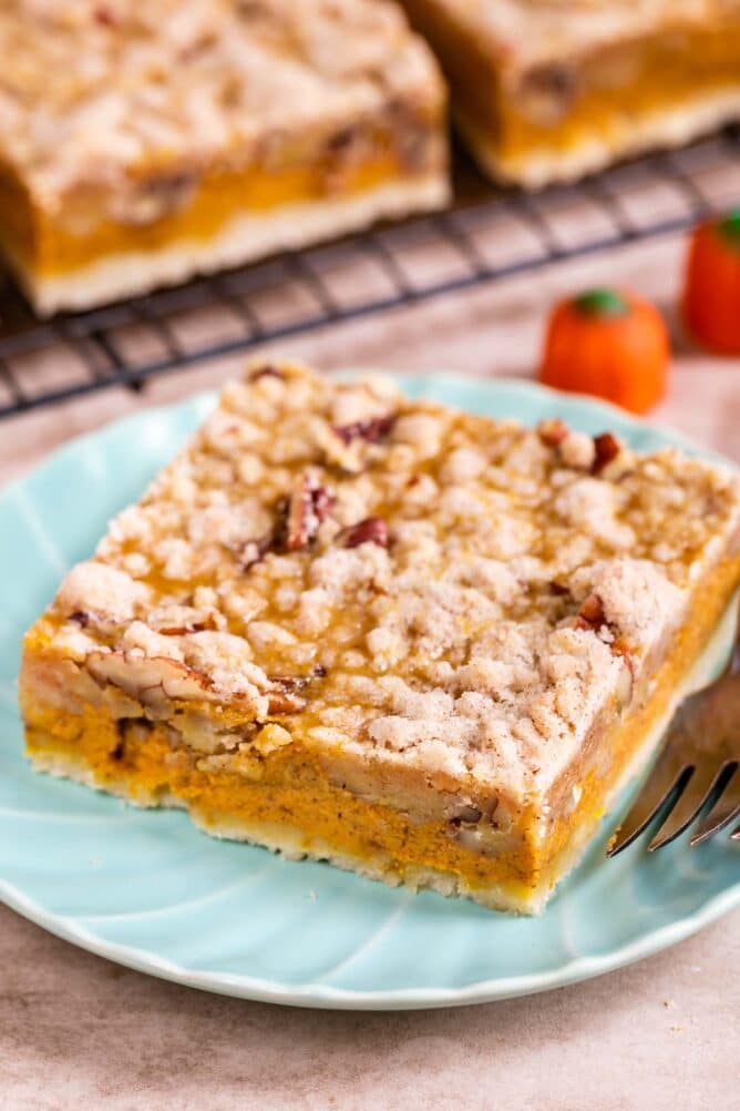 Pumpkin pie bar cut into a square on a light blue plate