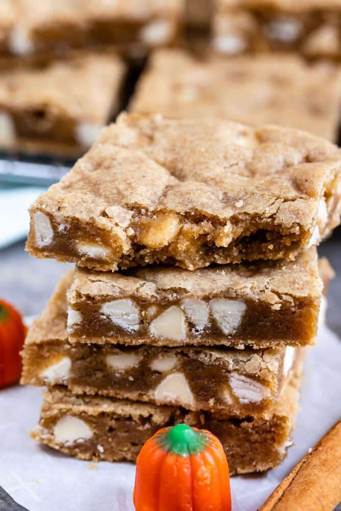 Stack of four pumpkin spice blondies with top blondie missing one bite