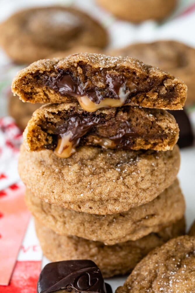 stack of cookies with cut open gooey cookies on top