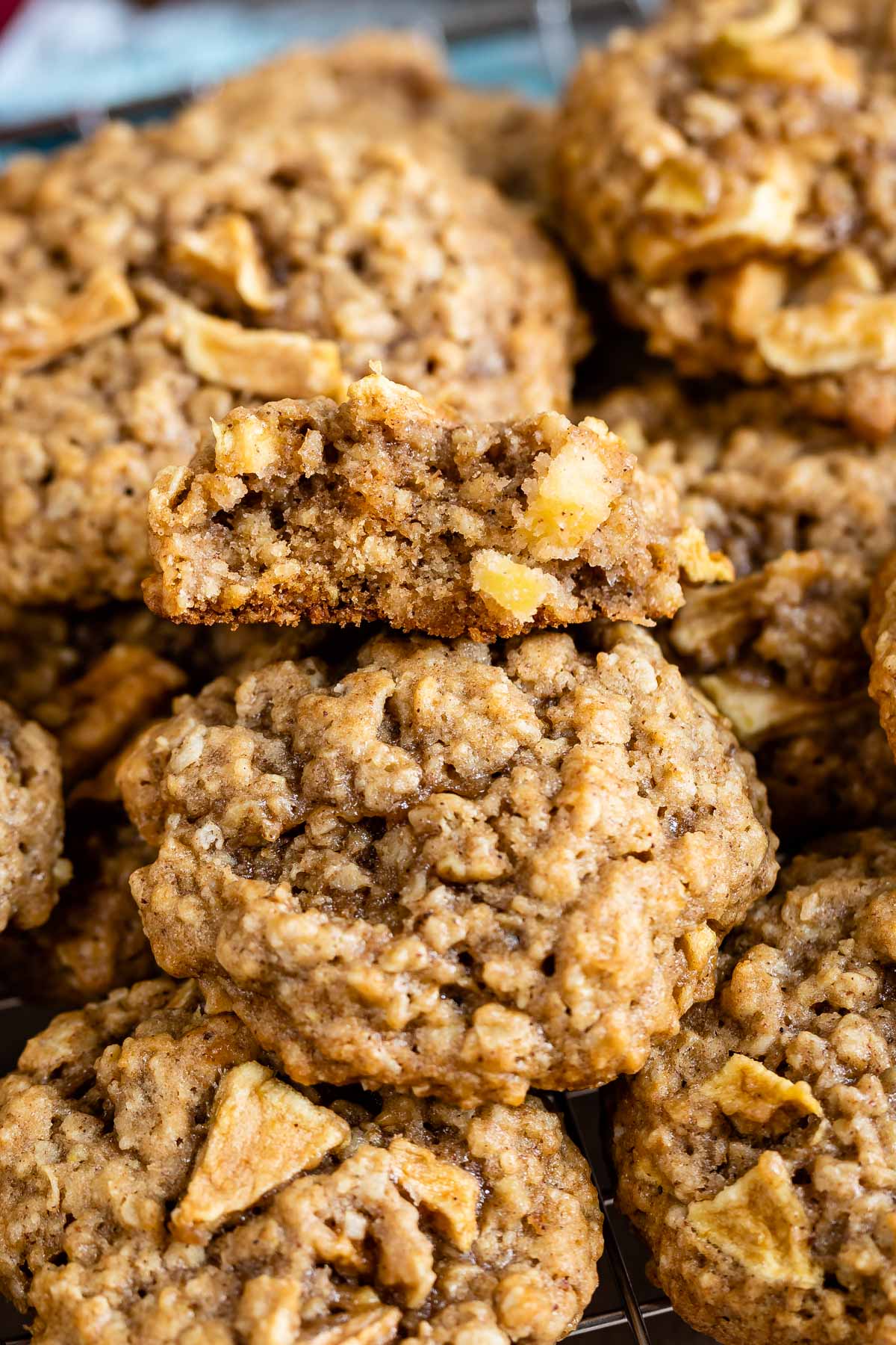 Close up shot of apple oatmeal cookies with one split in half to show inside of cookie