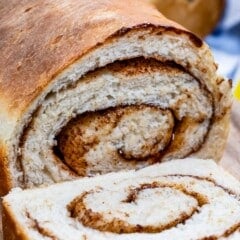 loaf of bread with slice showing cinnamon swirl.