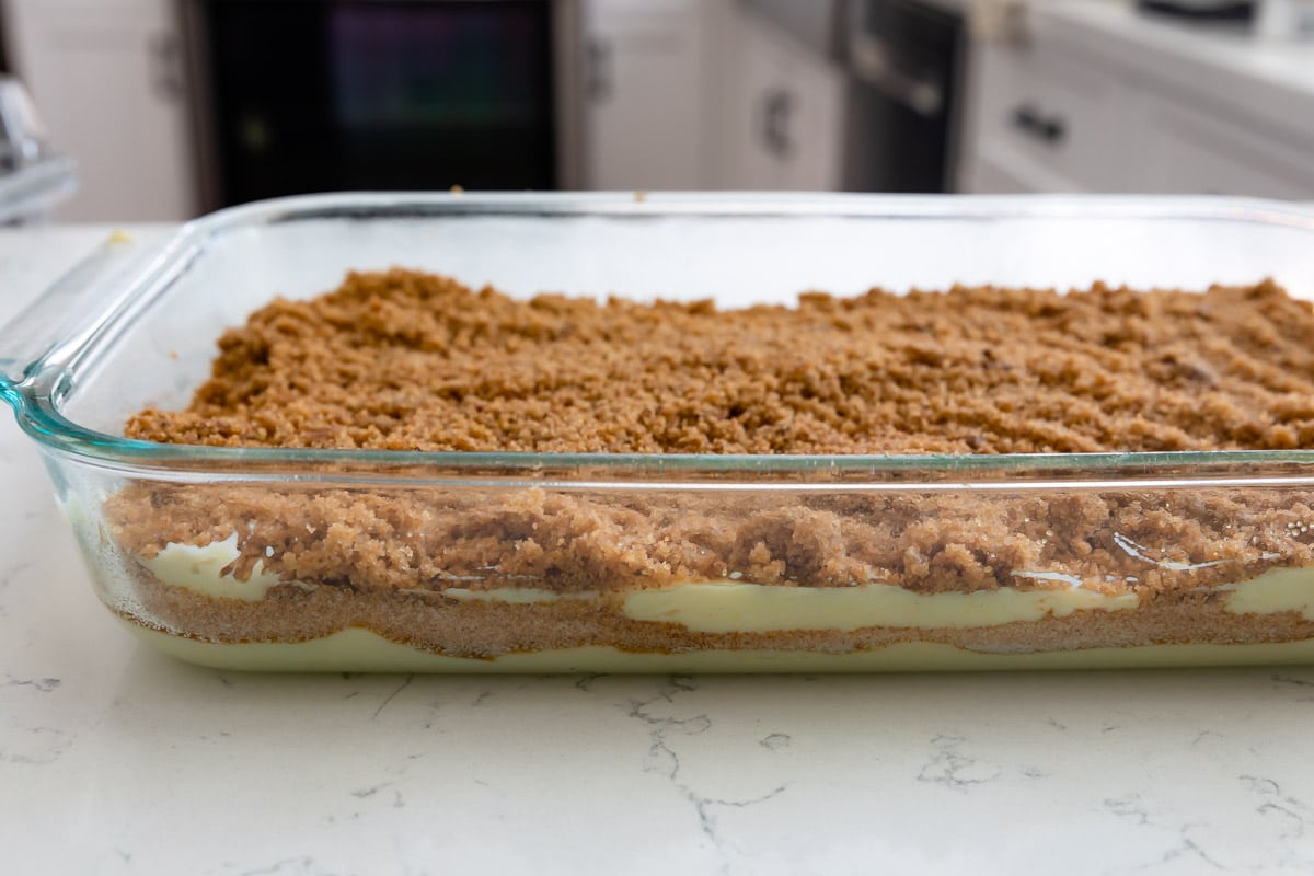 Side view of streusel coffee cake in a clear baking dish