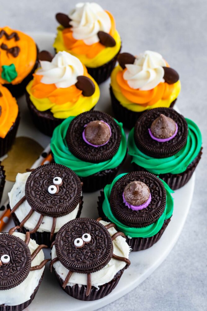 Overhead shot of halloween cupcakes decorated as spiders, witches hats and mickey mouse