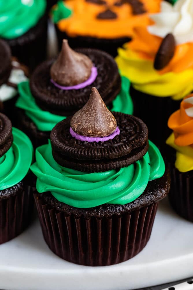 Green halloween cupcakes decorated with witches tops