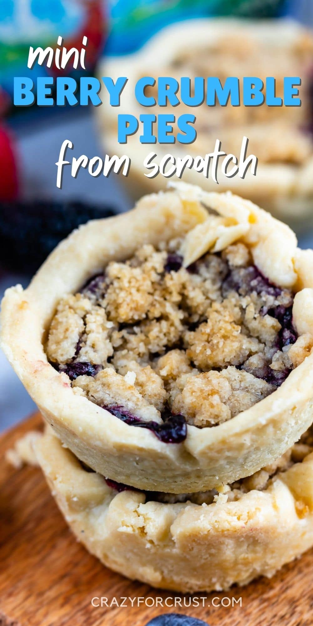 Two mini berry crumb pies stacked on top of eachother with recipe title on top of image