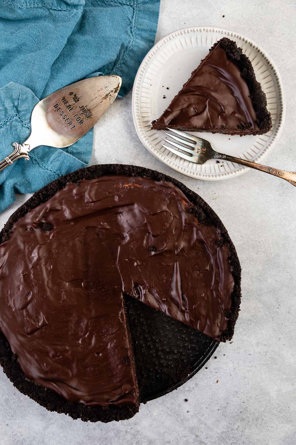 Overhead shot of mississippi mud pie with one slice on a plate next to rest of pie