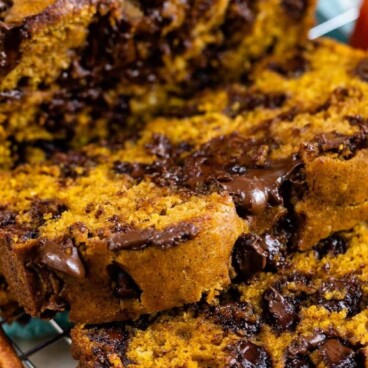 Loaf of pumpkin chocolate chip bread with recipe title on the top of image