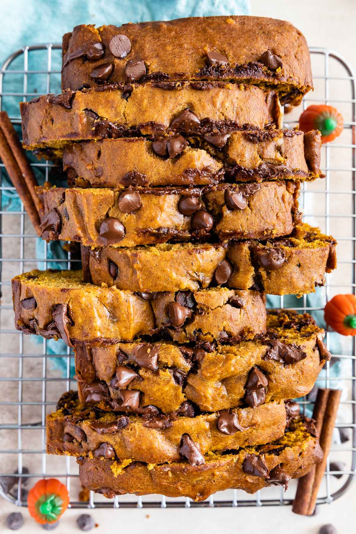 Overhead shot of sliced pumpkin chocolate chip bread on metal cooling rack