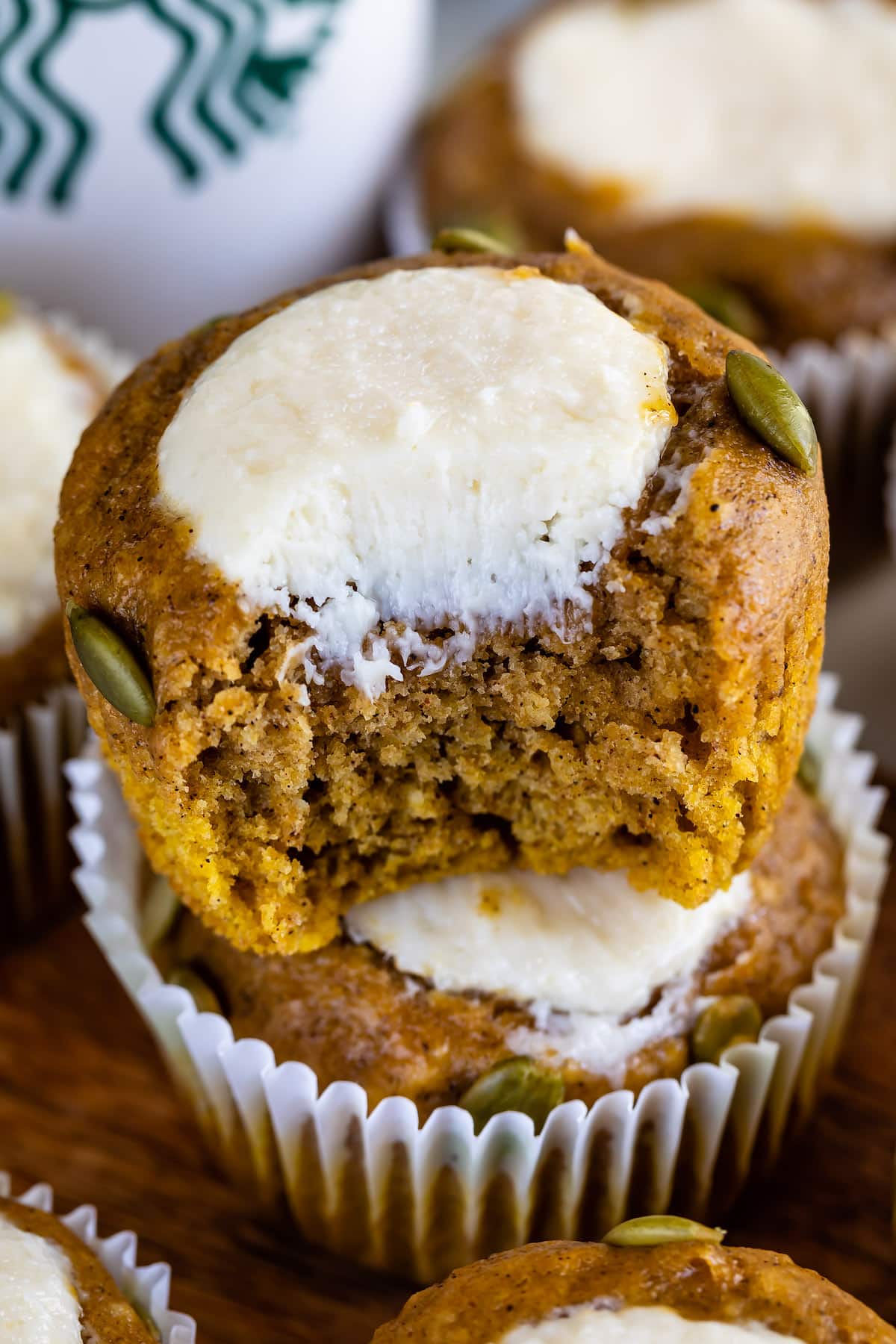 muffins with seeds and cream cheese in the center and bite missing